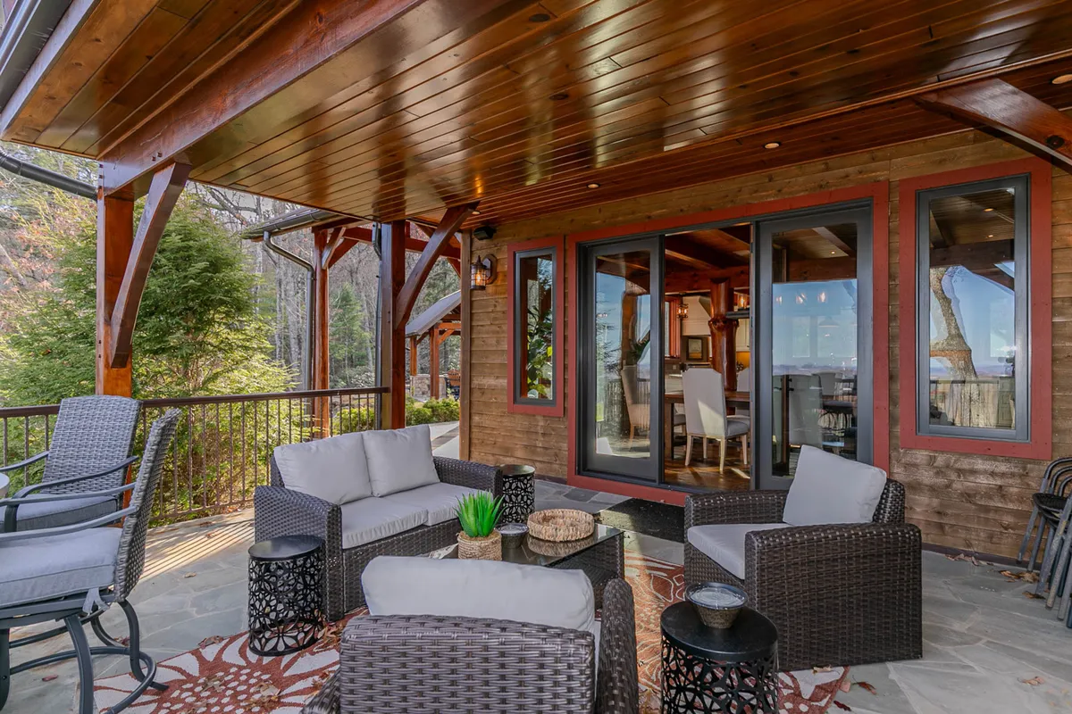 This exterior image presents a comfortable outdoor seating area with a decorative table, set amidst tranquil natural surroundings. The arrangement suggests a perfect spot for morning coffee, afternoon relaxation, or evening stargazing after a day spent exploring.